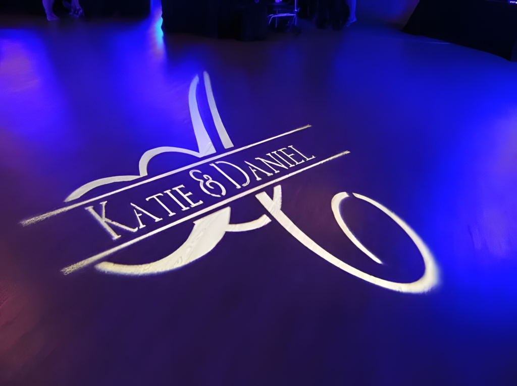 Custom DJ for wedding monograms projecting couple’s names on dance floor